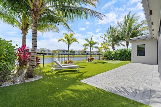 view of yard with a water view, a patio area, and a residential view