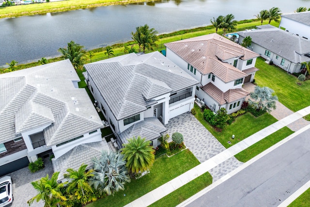 aerial view of residential area featuring a large body of water