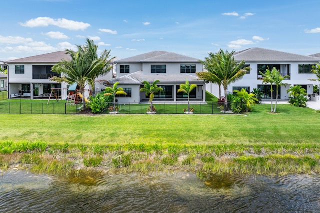rear view of property with a water view and stucco siding