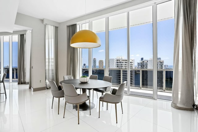 dining space featuring a view of city, light tile patterned flooring, and baseboards