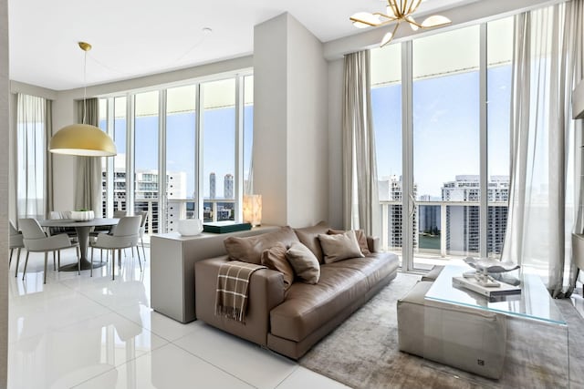 living area with a view of city, a chandelier, and light tile patterned floors