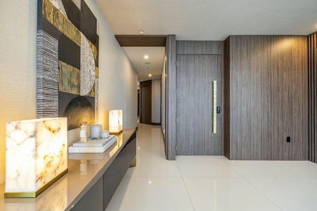 corridor with light tile patterned floors and recessed lighting