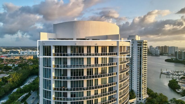 view of building exterior with a water view and a view of city