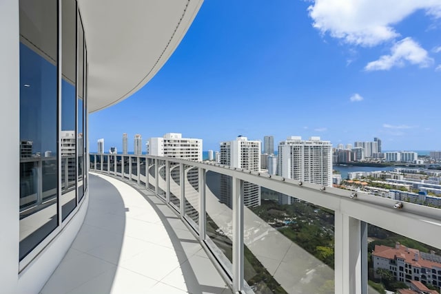 balcony with a view of city and a water view