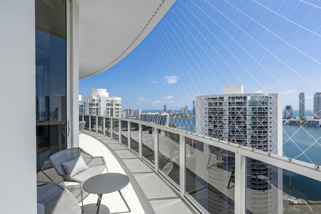 balcony featuring a water view and a view of city