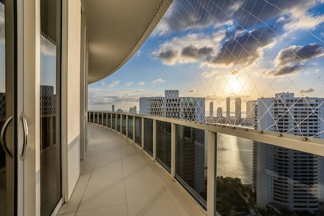 balcony featuring a view of city and a water view