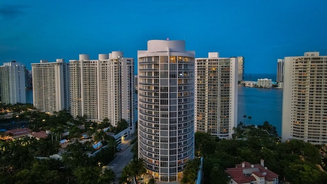 birds eye view of property featuring a water view and a city view