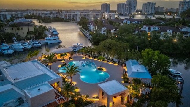 aerial view at dusk with a view of city and a water view