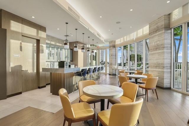 dining space with light wood-type flooring and visible vents
