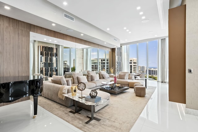 living room featuring tile patterned floors, plenty of natural light, visible vents, and expansive windows