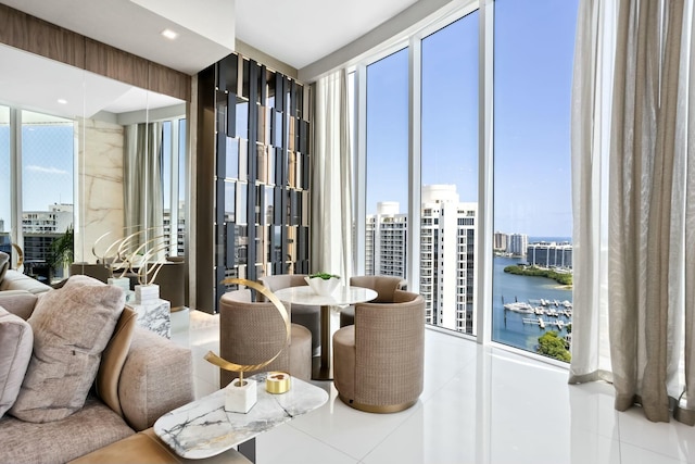 tiled dining room featuring a view of city and a water view