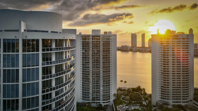 view of property featuring a water view and a view of city
