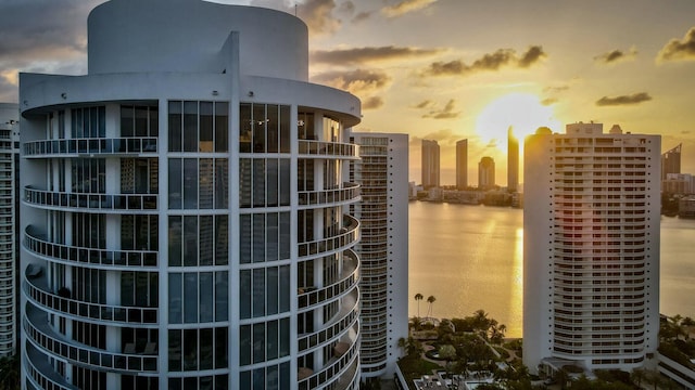 exterior space with central AC, a view of city, and a water view
