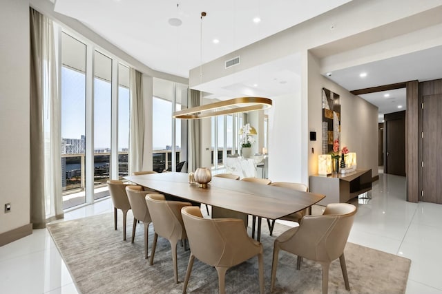 dining space featuring light tile patterned flooring