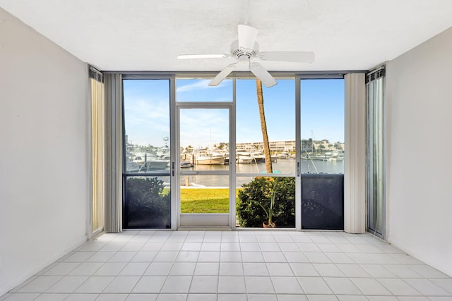 21 Yacht Club Dr Unit 102, North Palm Beach, FL 33408 - unfurnished room featuring a wall of windows, a water view, a ceiling fan, and a healthy amount of sunlight