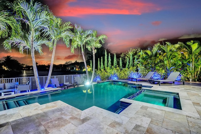 view of pool featuring a patio and a pool with connected hot tub