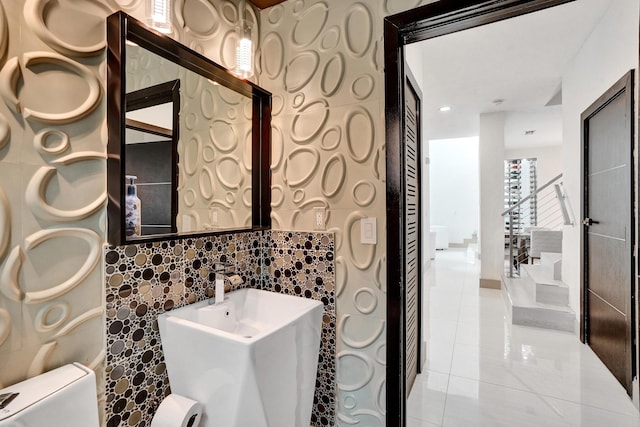 bathroom with toilet and tile patterned floors