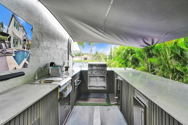 view of patio with a sink, an outdoor kitchen, grilling area, and outdoor wet bar