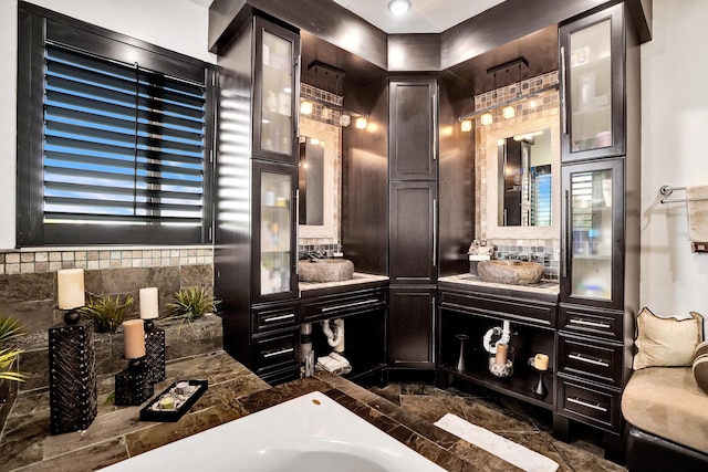 full bathroom with backsplash, a bath, and vanity