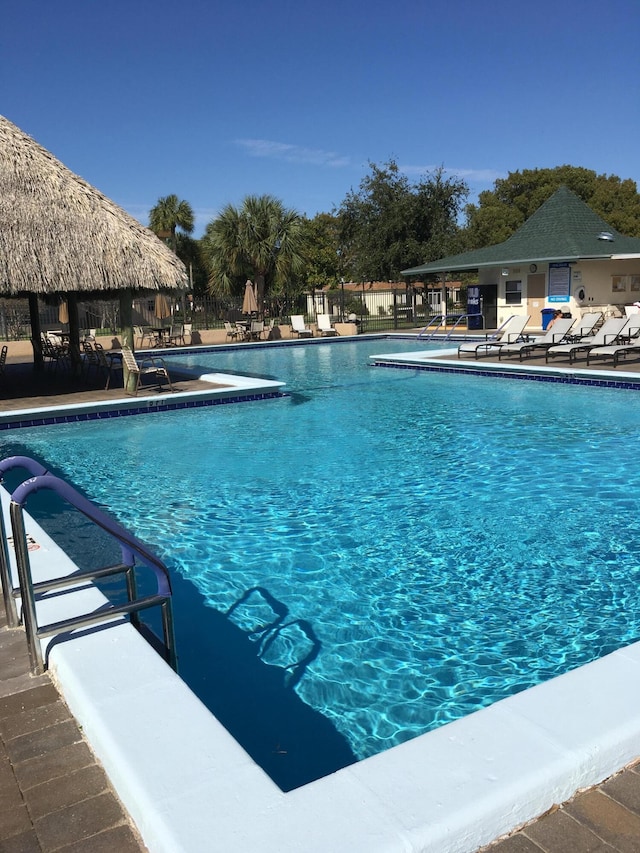 community pool with fence, a patio, and a gazebo