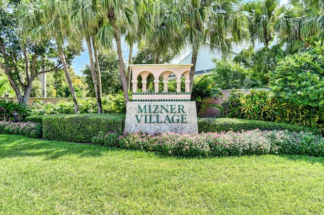 community sign featuring a lawn