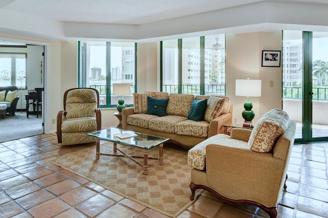 living area featuring french doors, plenty of natural light, and tile patterned flooring