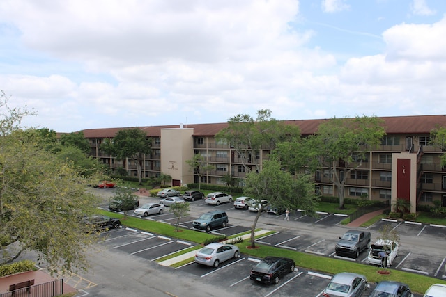 view of building exterior featuring uncovered parking
