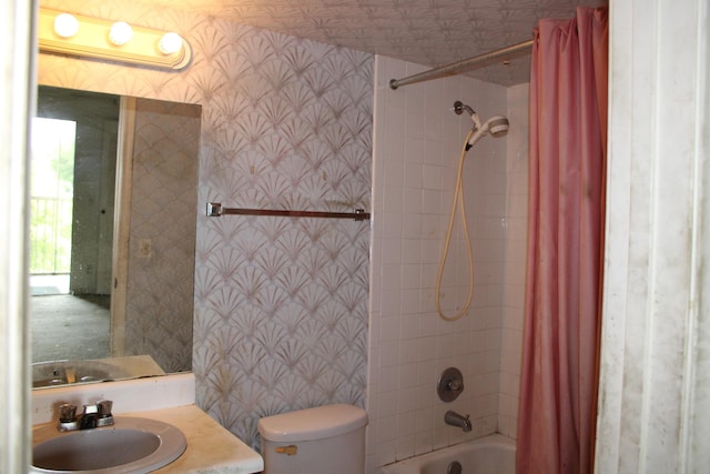 bathroom featuring vanity, shower / bath combination with curtain, toilet, and wallpapered walls