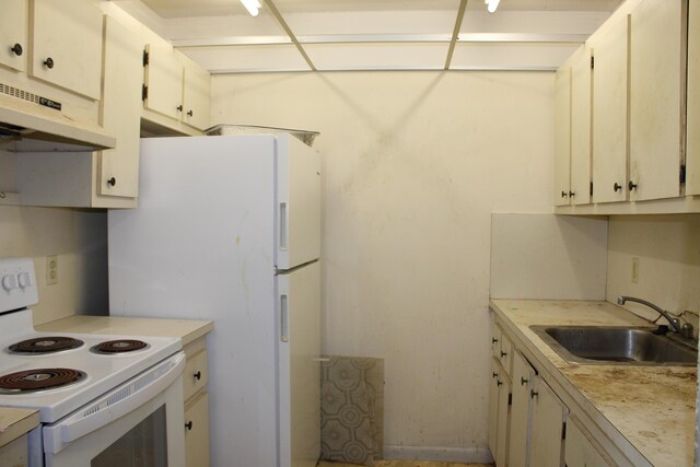 kitchen featuring a sink, light countertops, white electric stove, and under cabinet range hood