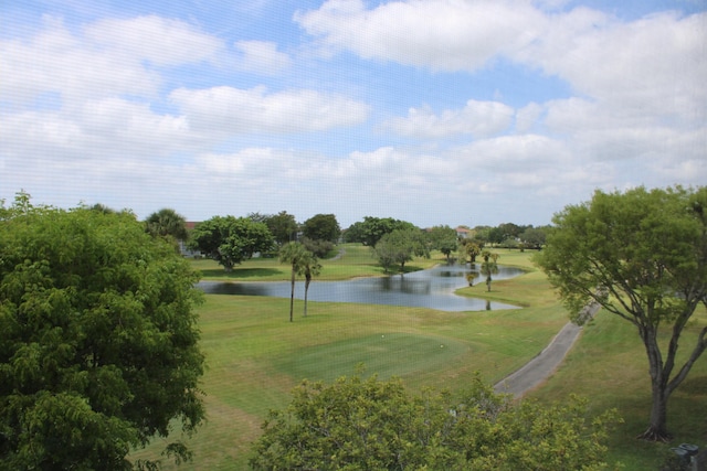 view of property's community featuring a water view, view of golf course, and a yard