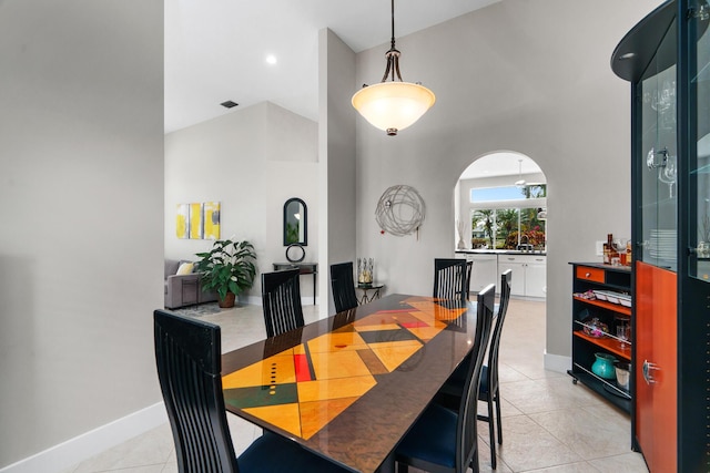 19699 Dinner Key Dr, Boca Raton, FL 33498 - dining room featuring light tile patterned flooring, arched walkways, visible vents, and a towering ceiling