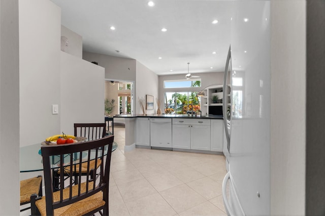 19699 Dinner Key Dr, Boca Raton, FL 33498 - kitchen with recessed lighting, white appliances, dark countertops, white cabinets, and a sink