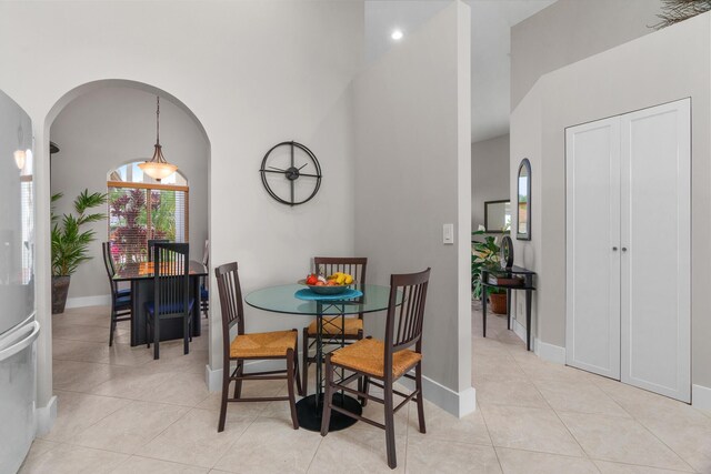 19699 Dinner Key Dr, Boca Raton, FL 33498 - dining space with light tile patterned floors, baseboards, and arched walkways