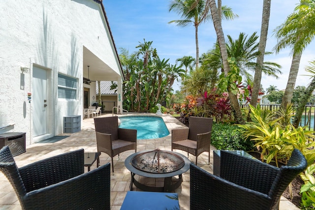 19699 Dinner Key Dr, Boca Raton, FL 33498 - view of patio with ceiling fan, an outdoor fire pit, and an outdoor pool