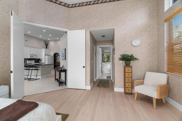 19699 Dinner Key Dr, Boca Raton, FL 33498 - interior space featuring light wood-style flooring, visible vents, a towering ceiling, and baseboards