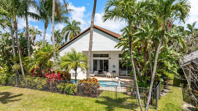 19699 Dinner Key Dr, Boca Raton, FL 33498 - back of property featuring a yard, fence, a patio, and stucco siding