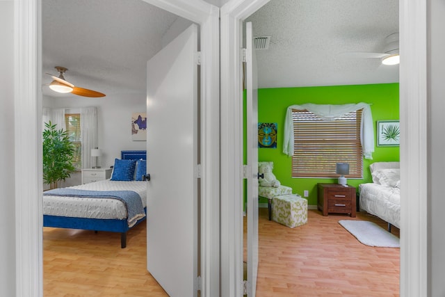 19699 Dinner Key Dr, Boca Raton, FL 33498 - bedroom with ceiling fan, wood finished floors, a textured ceiling, and visible vents