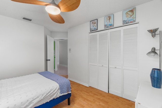 19699 Dinner Key Dr, Boca Raton, FL 33498 - bedroom with light wood-type flooring, baseboards, visible vents, a closet, and ceiling fan
