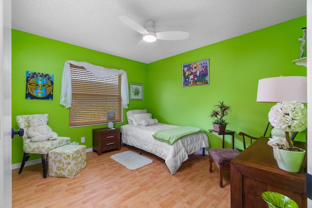 19699 Dinner Key Dr, Boca Raton, FL 33498 - bedroom featuring ceiling fan, baseboards, wood finished floors, and a textured ceiling