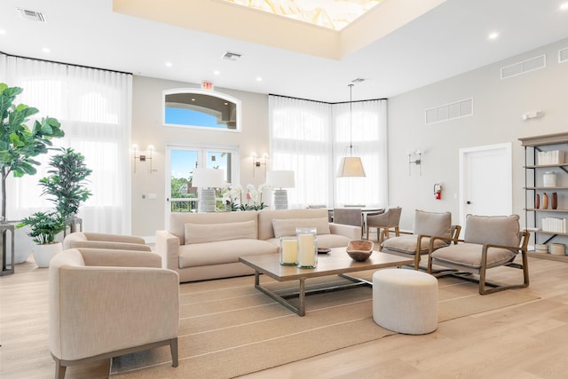 19699 Dinner Key Dr, Boca Raton, FL 33498 - living area featuring visible vents, a towering ceiling, and light wood-style floors