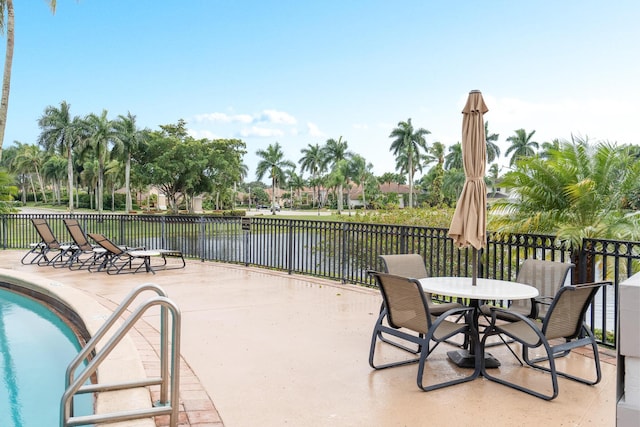 19699 Dinner Key Dr, Boca Raton, FL 33498 - view of patio featuring fence, a community pool, and a water view