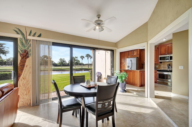 8326 Mooring Cir, Boynton Beach, FL 33472 - dining space featuring a water view, ceiling fan, lofted ceiling, plenty of natural light, and light tile patterned floors