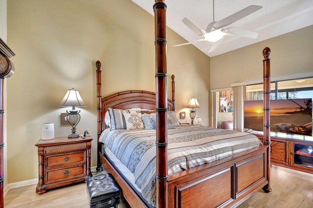 8326 Mooring Cir, Boynton Beach, FL 33472 - bedroom featuring light wood-style floors, vaulted ceiling, and baseboards