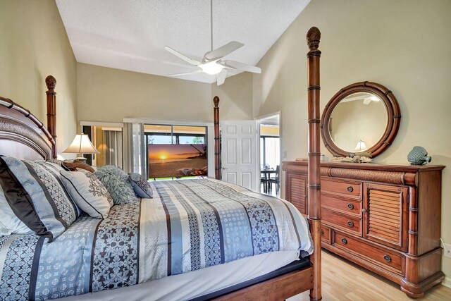 8326 Mooring Cir, Boynton Beach, FL 33472 - bedroom featuring access to exterior, wood finished floors, high vaulted ceiling, ceiling fan, and a textured ceiling