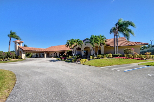 8326 Mooring Cir, Boynton Beach, FL 33472 - mediterranean / spanish-style home featuring uncovered parking, stucco siding, a tile roof, and a front yard