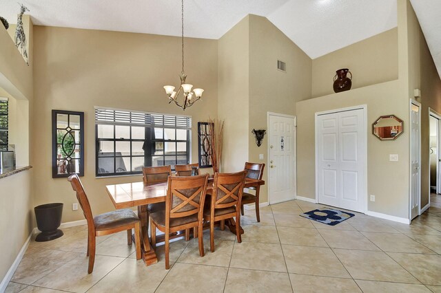 8326 Mooring Cir, Boynton Beach, FL 33472 - dining space featuring high vaulted ceiling, a chandelier, baseboards, and light tile patterned floors
