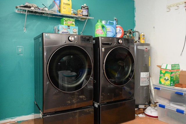 washroom with water heater, washing machine and clothes dryer, and laundry area
