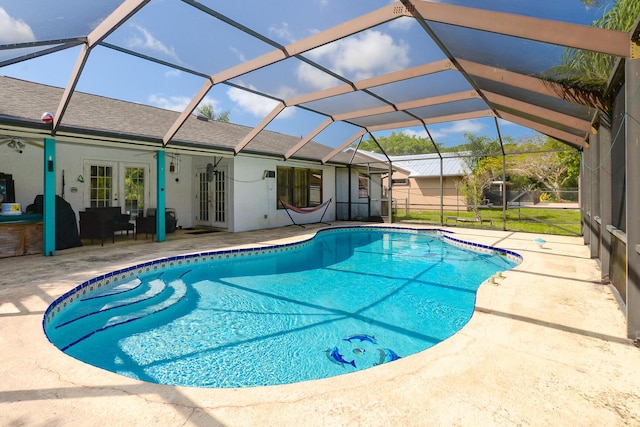 outdoor pool featuring a patio area, french doors, and glass enclosure