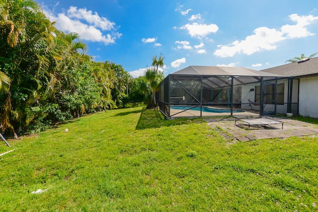 view of yard featuring an outdoor pool, glass enclosure, and a patio