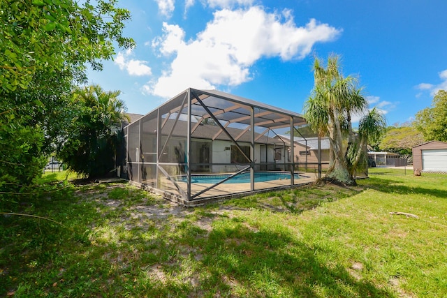 pool with a yard, fence, and a lanai